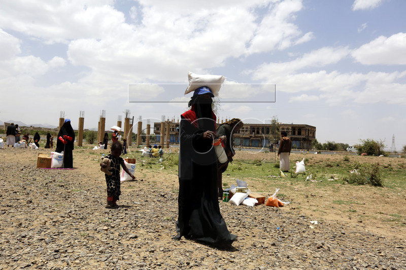 epa07549993 Displaced Yemenis receive food rations provided by Mona Relief Yemen ahead of the holy fasting month of Ramadan at a camp for Internally Displaced Persons (IDPs) on the outskirts of Sana'a, Yemen, 05 May 2019. A four-year long conflict in Yemen has created the worst humanitarian crisis in the world, where some 80 percent of Yemen's 26-million population are in need of humanitarian assistance. Muslims around the world celebrate the holy month of Ramadan by praying during the night time and abstaining from eating, drinking, and sexual acts during the period between sunrise and sunset. Ramadan is the ninth month in the Islamic calendar and it is believed that the revelation of the first verse in Koran was during its last 10 nights.  EPA-EFE/YAHYA ARHAB
