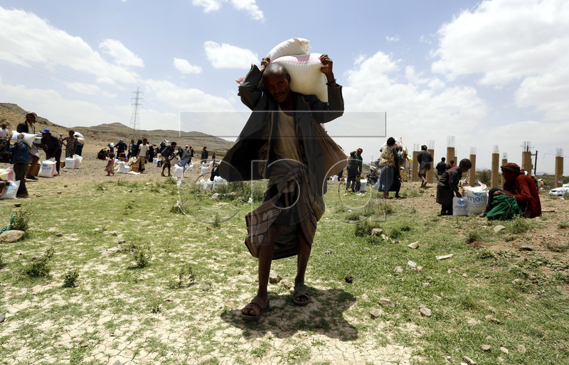 epa07549988 Displaced Yemenis receive food rations provided by Mona Relief Yemen ahead of the holy fasting month of Ramadan at a camp for Internally Displaced Persons (IDPs) on the outskirts of Sana'a, Yemen, 05 May 2019. A four-year long conflict in Yemen has created the worst humanitarian crisis in the world, where some 80 percent of Yemen's 26-million population are in need of humanitarian assistance. Muslims around the world celebrate the holy month of Ramadan by praying during the night time and abstaining from eating, drinking, and sexual acts during the period between sunrise and sunset. Ramadan is the ninth month in the Islamic calendar and it is believed that the revelation of the first verse in Koran was during its last 10 nights.  EPA-EFE/YAHYA ARHAB