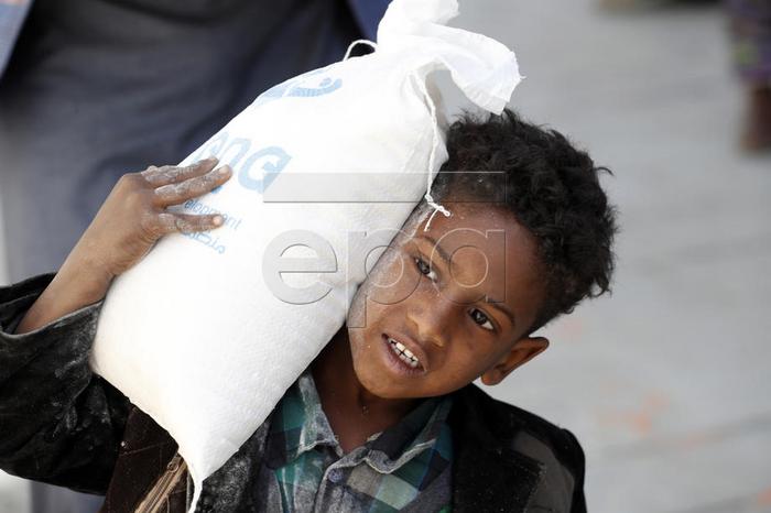 epa08002320 A conflict affected Yemeni child gets food rations provided by Mona Relief Yemen in Sanaa, Yemen, 16 November 2019. According to reports, the ongoing conflict in Yemen since 2015 has created the worst humanitarian crisis in the world, with 10 million people living with extreme hunger and two million children under five already acutely malnourished, as the Arab country enters its fifth year of armed conflict between the Saudi-backed Yemeni government forces and the Houthi rebels.  EPA-EFE/YAHYA ARHAB