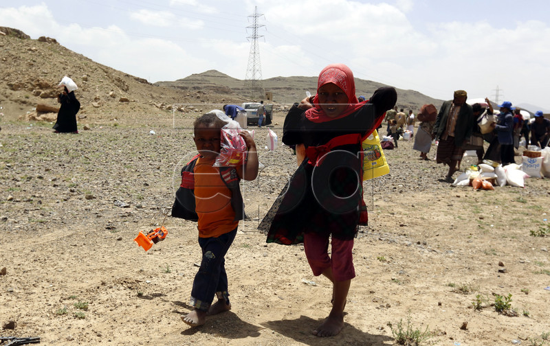 epa07550020 Displaced Yemeni children receive food rations provided by Mona Relief Yemen ahead of the holy fasting month of Ramadan at a camp for Internally Displaced Persons (IDPs) on the outskirts of Sana'a, Yemen, 05 May 2019. A four-year long conflict in Yemen has created the worst humanitarian crisis in the world, where some 80 percent of Yemen's 26-million population are in need of humanitarian assistance. Muslims around the world celebrate the holy month of Ramadan by praying during the night time and abstaining from eating, drinking, and sexual acts during the period between sunrise and sunset. Ramadan is the ninth month in the Islamic calendar and it is believed that the revelation of the first verse in Koran was during its last 10 nights.  EPA-EFE/YAHYA ARHAB